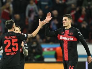 Bayer Leverkusen's Czech forward #14 Patrik Schick (C) celebrates scoring the 3-2 goal with team mate Bayer Leverkusen's Argentine midfielder #25 Exequiel Palacios during the UEFA Europa League Group round of 16, second-leg football match between Bayer 04 Leverkusen and Garabagh in Leverkusen, western Germany on March 14, 2024. (Photo by INA FASSBENDER / AFP)