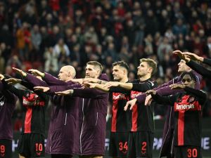 Bayer Leverkusen's players celebrate with fans at the end of the UEFA Europa League Group round of 16, second-leg football match between Bayer 04 Leverkusen and Garabagh in Leverkusen, western Germany on March 14, 2024. Bayer Leverkusen won the match 3-2. (Photo by INA FASSBENDER / AFP)