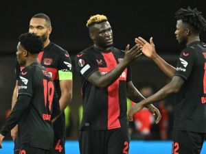 Bayer Leverkusen's Nigerian forward #22 Victor Boniface (2R) celebrates scoring his team's second goal with Bayer Leverkusen's Burkinabe defender #12 Edmond Tapsoba (R) and teammates Bayer Leverkusen's German defender #04 Jonathan Tah (2L) and Bayer Leverkusen's English midfielder #19 Nathan Tella during the UEFA Europa League quarter-final first leg football match between Bayer 04 Leverkusen and West Ham United FC in Leverkusen, western Germany on April 11, 2024. (Photo by INA FASSBENDER / AFP)