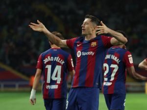 Barcelona's Polish forward #09 Robert Lewandowski celebrates after scoring his team's third goal during the Spanish league football match between FC Barcelona and Valencia CF at the Estadi Olimpic Lluis Companys in Barcelona on April 29, 2024. (Photo by LLUIS GENE / AFP)