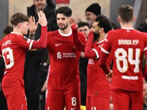 Liverpool's Hungarian midfielder #08 Dominik Szoboszlai celebrates scoring the team's fifth goal with Liverpool's English midfielder #53 James McConnell and Liverpool's Egyptian striker #11 Mohamed Salah during the UEFA Europa League round of 16 second leg football match between Liverpool and AC Sparta Praha at Anfield in Liverpool, north west England on March 14, 2024. (Photo by Oli SCARFF / AFP)