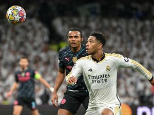 Real Madrid's English midfielder #5 Jude Bellingham vies with Manchester City's Swiss defender #25 Manuel Akanji during the UEFA Champions League quarter final first leg football match between Real Madrid CF and Manchester City at the Santiago Bernabeu stadium in Madrid on April 9, 2024. (Photo by JAVIER SORIANO / AFP)