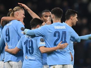 Manchester City's Norwegian striker #09 Erling Haaland (L) celebrates with teammates after scoring their third goal during the UEFA Champions League round of 16, second-leg, football match between Manchester City and FC Copenhagen at the Etihad Stadium, in Manchester, north west England, on March 6, 2024. (Photo by Paul ELLIS / AFP)