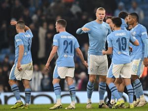 Manchester City's players celebrate on the pitch after the UEFA Champions League round of 16, second-leg, football match between Manchester City and FC Copenhagen at the Etihad Stadium, in Manchester, north west England, on March 6, 2024. City won the game 3-1, 6-2 on aggregate. (Photo by Paul ELLIS / AFP)