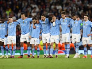 Manchester City players react during the penalty shootout during the UEFA Champions League quarter-final second-leg football match between Manchester City and Real Madrid, at the Etihad Stadium, in Manchester, north-west England, on April 17, 2024. (Photo by Darren Staples / AFP)