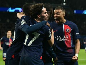 Paris Saint-Germain's French forward #07 Kylian Mbappe (R) celebrates after Paris Saint-Germain's French forward #10 Ousmane Dembele (C) scored an equalizer during the UEFA Champions League quarter final first leg football match between Paris Saint-Germain (PSG) and FC Barcelona at the Parc des Princes stadium in Paris on April 10, 2024. (Photo by MIGUEL MEDINA / AFP)