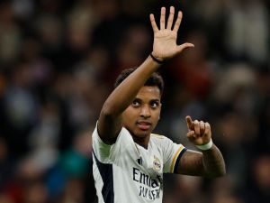 Real Madrid's Brazilian forward #11 Rodrygo celebrates after scoring his team's second goal during the Spanish league football match between Real Madrid CF and Granada FC at the Santiago Bernabeu stadium in Madrid on December 1, 2023. (Photo by OSCAR DEL POZO / AFP)
