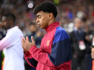 Barcelona's Spanish forward #27 Lamine Yamal prays as he enters the pitch during the UEFA Champions League quarter-final second leg football match between FC Barcelona and Paris SG at the Estadi Olimpic Lluis Companys in Barcelona on April 16, 2024. (Photo by Josep LAGO / AFP)