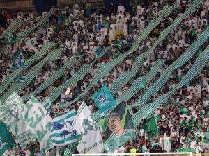 Ahli's supporters lift banners during the Saudi Pro League football match between Al-Nassr and Al-Ahli at the King Saud University Stadium in Riyadh, on September 22, 2023. (Photo by Fayez Nureldine / AFP)