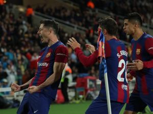 Barcelona's Polish forward #09 Robert Lewandowski celebrates with teammates after scoring his team's third goal during the Spanish league football match between FC Barcelona and Valencia CF at the Estadi Olimpic Lluis Companys in Barcelona on April 29, 2024. (Photo by LLUIS GENE / AFP)