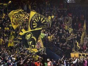 Dortmund fans celebrate their victory at the end of their UEFA Champions League semi-final second leg football match against Paris Saint-Germain (PSG) at the Parc des Princes stadium in Paris on May 7, 2024. (Photo by MIGUEL MEDINA / AFP)