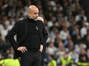 Manchester City's Spanish manager Pep Guardiola watches his players from the touchline during the UEFA Champions League quarter final first leg football match between Real Madrid CF and Manchester City at the Santiago Bernabeu stadium in Madrid on April 9, 2024. (Photo by JAVIER SORIANO / AFP)