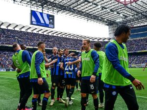 Inter Milan's Turkish midfielder #20 Hakan Calhanoglu celebrates with teammates after scoring his team second goal during the Italian Serie A football match between Inter Milan and Torino at the San Siro Stadium in Milan, on April 28, 2024. Inter clinched their 20th Scudetto with a 2-1 victory over AC Milan on April 22, 2024. (Photo by Piero CRUCIATTI / AFP)