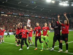 Bayer Leverkusen's Spanish head coach Xabi Alonso celebrates with the players after the UEFA Europa League semi final second leg football match between Bayer Leverkusen and ASC Roma in Leverkusen, on May 9, 2024. (Photo by INA FASSBENDER / AFP)