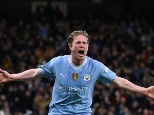 Manchester City's Belgian midfielder #17 Kevin De Bruyne celebrates after scoring his team first and equalising goal during the UEFA Champions League quarter-final second-leg football match between Manchester City and Real Madrid, at the Etihad Stadium, in Manchester, north-west England, on April 17, 2024. (Photo by Paul ELLIS / AFP)