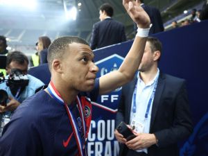 Paris Saint-Germain's French forward #07 Kylian Mbappe waves goodbye to PSG supporters after playing his final match for Paris Saint-Germain (PSG) at the end of the French Cup Final football match against Olympique Lyonnais (OL) at the Stade Pierre-Mauroy, in Villeneuve-d'Ascq, northern France on May 25, 2024. The game was the club's top scorer's 308th and final appearance for his hometown club, for whom he signed in August 2017 from Monaco in a 180 million-euro deal. (Photo by FRANCK FIFE / AFP)