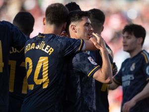 Real Madrid's Spanish forward #21 Brahim Diaz celebrates with teammates after scoring during the Spanish League football match between Granada FC and Real Madrid CF at Nuevo Los Carmenes stadium in Granada on May 11, 2024. (Photo by JORGE GUERRERO / AFP)