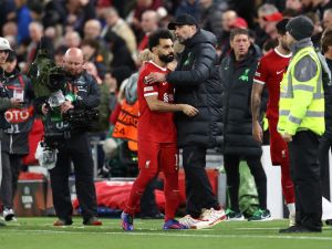 Liverpool's German manager Jurgen Klopp talks with Liverpool's Egyptian striker #11 Mohamed Salah during half-time in the UEFA Europa League quarter-final first leg football match between Liverpool and Atalanta at Anfield in Liverpool, north west England on April 11, 2024. (Photo by Darren Staples / AFP)