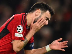 Manchester United's Portuguese midfielder #08 Bruno Fernandes reacts in pain during the UEFA Champions League group A football match between Manchester United and FC Bayern Munich at Old Trafford stadium in Manchester, north west England, on December 12, 2023. (Photo by PETER POWELL / AFP)