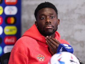 Canada's midfielder #19 Alphonso Davies speaks during a press conference one day before the Conmebol 2024 Copa America tournament group A football match between Argentina and Canada at Mercedes Benz Stadium in Atlanta, Georgia, on June 19, 2024. (Photo by Charly TRIBALLEAU / AFP)