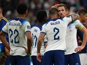 England's defender #02 Kyle Walker and England's forward #09 Harry Kane react at the end of the Qatar 2022 World Cup quarter-final football match between England and France at the Al-Bayt Stadium in Al Khor, north of Doha, on December 10, 2022. (Photo by Paul ELLIS / AFP)