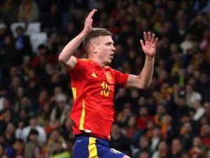 Spain's midfielder #10 Dani Olmo (up) celebrates scoring his team's second goal during the international friendly football match between Spain and Brazil at the Santiago Bernabeu stadium in Madrid, on March 26, 2024. Spain arranged a friendly against Brazil at the Santiago Bernabeu under the slogan "One Skin" to help combat racism. (Photo by Pierre-Philippe MARCOU / AFP)