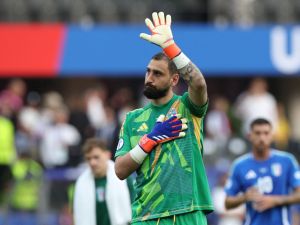 Italy's goalkeeper #01 Gianluigi Donnarumma waves to supporters at the end of the UEFA Euro 2024 round of 16 football match between Switzerland and Italy at the Olympiastadion Berlin in Berlin on June 29, 2024. (Photo by Ronny HARTMANN / AFP)