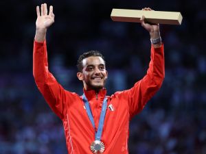 Bronze medallist Egypt's Mohamed Elsayed celebrates on the podium during the medal ceremony for the men's epee individual competition during the Paris 2024 Olympic Games at the Grand Palais in Paris, on July 28, 2024. (Photo by Franck FIFE / AFP)