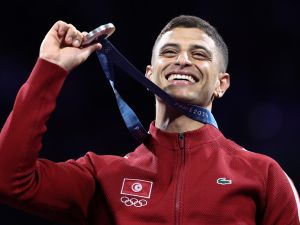 Silver medallist Tunisia's Fares Ferjani celebrates on the podium during the medal ceremony for the men's sabre individual competition during the Paris 2024 Olympic Games at the Grand Palais in Paris, on July 27, 2024. (Photo by Franck FIFE / AFP)