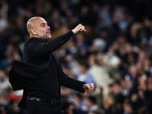 Manchester City's Spanish manager Pep Guardiola celebrates following his team first goal scored by Manchester City's Belgian midfielder #17 Kevin De Bruyne during the UEFA Champions League quarter-final second-leg football match between Manchester City and Real Madrid, at the Etihad Stadium, in Manchester, north-west England, on April 17, 2024. (Photo by Darren Staples / AFP)