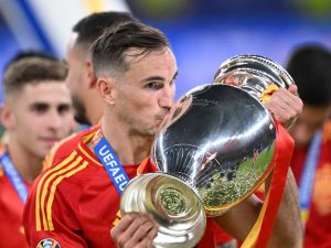 Spain's midfielder #08 Fabian Ruiz celebrates with the trophy after winning the UEFA Euro 2024 final football match between Spain and England at the Olympiastadion in Berlin on July 14, 2024. (Photo by Kirill KUDRYAVTSEV / AFP)