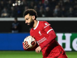 Liverpool's Egyptian forward #11 Mohamed Salah celebrates after scoring a penalty during the UEFA Europa League quarter-final second leg football match between Atalanta BC and Liverpool FC at the Atleti Azzurri d'Italia Stadium in Bergamo, on April 18, 2024. (Photo by Isabella BONOTTO / AFP)