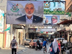 A large banner bearing a picture of slain Hamas political leader Ismail Haniyeh hangs in a street in the Palestinian refugee camp of Ain al-Hilweh, near the southern Lebanese city of Sidon on July 31, 2024. (Photo by Mahmoud ZAYYAT / AFP) Hamas political leader Ismail Haniyeh