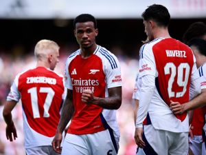 Arsenal's Brazilian defender #06 Gabriel Magalhaes celebrates scoring the team's second goal during the pre-season friendly football match for the Emirates Cup final between Arsenal and and Lyon, at the Emirates Stadium in London on August 11, 2024. (Photo by BENJAMIN CREMEL / AFP)