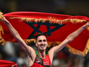 Morocco's Soufiane El Bakkali celebrates after winning the men's 3000m steeplechase final of the athletics event at the Paris 2024 Olympic Games at Stade de France in Saint-Denis, north of Paris, on August 7, 2024. (Photo by Jewel SAMAD / AFP)