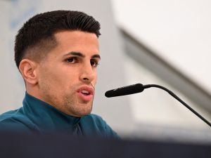 Portugal's defender #20 Joao Cancelo addresses a press conference at the media centre at the team base in Harsewinkel, western Germany on June 16, 2024, during the UEFA Euro 2024 football Championship. (Photo by PATRICIA DE MELO MOREIRA / AFP)