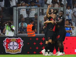 Bayer Leverkusen's players celebrate scoring their first goal during the pre-season friendly football match between Olympique Marseille (OM) and Bayer Leverkusen at the Stade Velodrome in Marseille, southern France on August 2, 2023. (Photo by CLEMENT MAHOUDEAU / AFP)