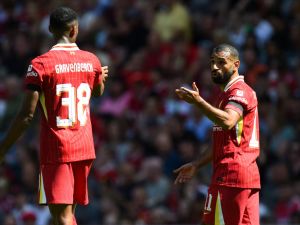 Liverpool's Egyptian striker #11 Mohamed Salah (R) talks to Liverpool's Dutch midfielder #38 Ryan Gravenberch during the pre-season friendly football match between Liverpool and Sevilla at Anfield stadium in Liverpool, northwest England on August 11, 2024. (Photo by Peter POWELL / AFP)