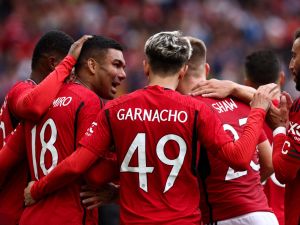 Manchester United's Brazilian midfielder Casemiro (L) celebrates scoring his team third goal during the pre-season friendly football match between Manchester United and Lens at Old Trafford stadium, in Manchester, on August 5, 2023. (Photo by Darren Staples / AFP)
