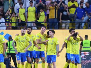 Nassr's Portuguese forward #07 Cristiano Ronaldo celebrates with teammates after scoring his second goal during the Saudi Pro League football match between Al-Ittihad and Al-Nassr at the King Saud University Stadium in Riyadh on May 27, 2024. (Photo by Fayez NURELDINE / AFP)
