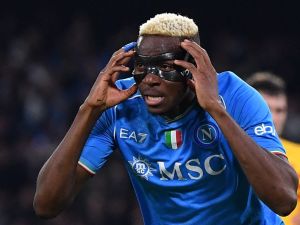 Napoli's Nigerian forward #09 Victor Osimhen celebrates after scoring a goal during the UEFA Champions League round of 16 first Leg football match between Napoli and Barcelona at the Diego-Armando-Maradona stadium in Naples on February 21, 2024. (Photo by Tiziana FABI / AFP)