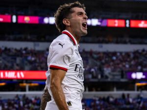 AC Milan's American forward #11 Christian Pulisic celebrates after scoring a goal during the pre-season club friendly football match between Barcelona and AC Milan at M&T Bank Stadium in Baltimore, Maryland, August 6, 2024. (Photo by SAMUEL CORUM / AFP)