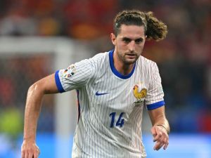 France's midfielder #14 Adrien Rabiot runs with the ball during the UEFA Euro 2024 semi-final football match between Spain and France at the Munich Football Arena in Munich on July 9, 2024. (Photo by Fabrice COFFRINI / AFP)