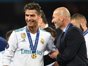 Real Madrid's former French coach Zinedine Zidane (R) celebrates with Real Madrid's former Portuguese forward Cristiano Ronaldo after winning the UEFA Champions League final football match between Liverpool and Real Madrid at the Olympic Stadium in Kiev, Ukraine, on May 26, 2018. (Photo by FRANCK FIFE / AFP)