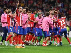 Atletico Madrid players celebrate their victory at the end of the UEFA Champions League 1st round football match between Club Atletico de Madrid and RB Leipzig at the Metropolitano stadium in Madrid on September 19, 2024. (Photo by Thomas COEX / AFP)