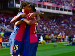 Barcelona's Brazilian forward #11 Raphinha celebrates scoring his team's first goal with Barcelona's Spanish forward #19 Lamine Yamal during the Spanish league football match between FC Barcelona and Real Valladolid FC at the Estadi Olimpic Lluis Companys in Barcelona on August 31, 2024. (Photo by MANU QUINTERO / AFP)