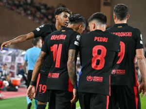 Barcelona's Spanish forward #19 Lamine Yamal (L) celebrates with teammates after scoring his team's first goal during the UEFA Champions League 1st round day 1 football match between AS Monaco and FC Barcelona at the Louis II Stadium in the Principality of Monaco on September 19, 2024. (Photo by Miguel MEDINA / AFP)