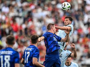 Croatia’s midfielder #15 Mario Pasalic and Portugal's defender #04 Ruben Dias jump for the ball during the international friendly football match between Portugal and Croatia at Jamor stadium in Oeiras on June 8, 2024. (Photo by PATRICIA DE MELO MOREIRA / AFP)