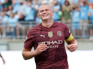 Manchester City's forward #09 Erling Haaland smiles after scoring his third goal during the second half of the pre-season club friendly football match between Chelsea FC and Manchester City FC at Ohio Stadium in Columbus, Ohio on August 3 2024. (Photo by KAMIL KRZACZYNSKI / AFP)