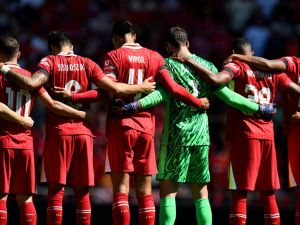 Players observe a minute's silence for the victims of the Southport attack before the pre-season friendly football match between Liverpool and Sevilla at Anfield stadium in Liverpool, northwest England on August 11, 2024. (Photo by Peter POWELL / AFP)